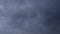 Invasion of dark blue clouds of a hurricane in the sky, background, time-lapse
