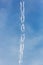 Inversion trail of aircraft in the sky with clouds