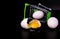 Inverted supermarket trolley with broken eggs on a black background. Copy space.