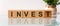 INVEST words written on wooden blocks. Investment business concept