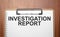 Investigation Report text on white paper on the wood table