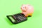 Investing gain profit. Piggy bank pig and calculator. Credit debt concept. Economics and profit management. Economics