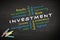 Investment concept written on blackboard