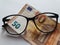 investment and promotion for a better vision, European banknote of fifty euro and black plastic frame glasses