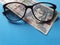 investment and promotion for a better vision, guatemalan banknote of twenty quetzales and black plastic frame glasses