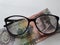 investment and promotion for a better vision, Honduran banknote of five lempiras and black plastic frame glasses