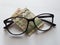investment and promotion for a better vision, Nepalese banknote of ten rupees and black plastic frame glasses