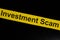 Investment scam and fraud alert, caution and warning concept. Yellow barricade tape with word