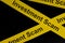 Investment scam and fraud alert, caution and warning concept. Yellow barricade tape with word