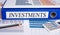 Investments - blue binder in the office