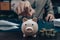 Investors hand putting money into piggy bank. Business saving money and financial concept
