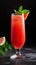 Invigorating tall glass of refreshing watermelon juice garnished with a sprig of fresh mint, a slice of juicy watermelon, and ice