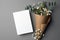 Invitation or greeting card mockup with natural eucalyptus and gypsophila flowers