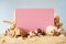 Invitation or greeting card mockup with seashells and starfish on the summer sandy beach at ocean background