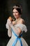 Invitation to taste. Young charming woman, royal person, queen or princess in white medieval outfit with juicy burger on