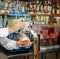 Inviting beautiful closeup view of bartender hands holding a wineglass and serving beer in the bar, restaurant