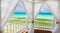 inviting pretty view through the fluffy open curtains of a beach gazebo during the preparation for a wedding ceremony