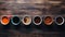 Inviting and warm overhead view of multiple coffee mugs artfully arranged on a rustic wooden table