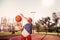 Involved dark-haired sportive girl improving her skills in basketball game