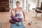 Involved young lady siting in weird pose during every day yoga training