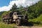 Inzer, Russia - July 19, 2014: KrAZ machine for logging with logs in forest on sunny summer day