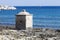 Ionian Sea. Small cubical building on the rocks. Blue sea