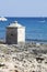 Ionian Sea. Small cubical building on the rocks. Blue sea