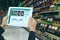 Iot smart retail in the futuristic concept, the retailer hold the tablet and use augmented reality technology monitor data of out