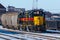 Iowa Interstate locomotives lashed to freight hoppers
