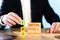 ipo concept. a man stacks wooden blocks with the words Initial, Public, Offering.