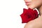 Ips, shoulder, part of the face of a woman. Red rose in her hands. Skin care concept. White background. the beauty