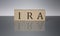 IRA concept, wooden word block on the grey background
