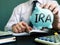 IRA Individual Retirement Account concept. Manager proposes piggy bank