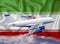 Iran flag with white airplane and clouds. The concept of tourist international passenger transportation