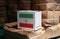 Iran flag on white box with barcode and the color of nation flag on the stack of brown box. The concept of export trading from