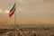 Iran Flag in the Wind Above Skyline of Tehran