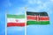 Iran and Kenya two flags on flagpoles and blue cloudy sky