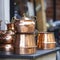 iran stack of copper kettles outside store