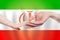 Irani baby and parent hands on the background of flag of Iran Help, aid, support, charity concept