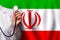 Irani doctor\\\'s hand with stethoscope on the background of flag of Iran Medicine, clinic, practitioner, healthcare