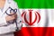 Irani medicine and healthcare concept. Doctor close up against flag of Iran background