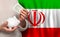 Irani woman with money bank on the background of Iran flag. Dotations, pension fund, poverty, wealth, retirement concept