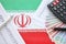 Iranian business calculations on table with iranian money and pen