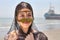 Iranian girl in traditional Muslim mask of southern Iran, smiling.