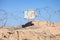 Iranian Traditional Scarf with Calligraphy on Barbered Wires in Desert