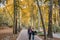 Iranian visitor walking in the park of Sa`dabad palace Complex in autumn, built by the Qajar and Pahlavi monarchs, located in