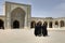 Iranian women wearing black islamic dresses in inner courtyard M