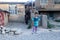 IranMazandaran, Iran - 19 July 2017: iranian kid in a rural area with her mom in burka and a persian carpet