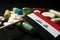 Iraqi flag with lot of medical pills isolated on black background