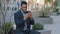 Irate annoyed angry African American black businessman holding smartphone looking at phone screen making business call